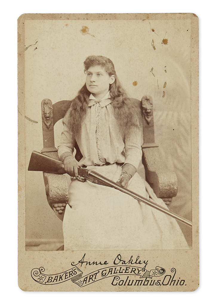 WEST) Cabinet card of Annie Oakley and her rifle